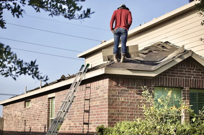 Professional roofer working on a residential roof in Zerby